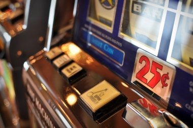 Boom City slot game interface with reels, paylines, and stake controls